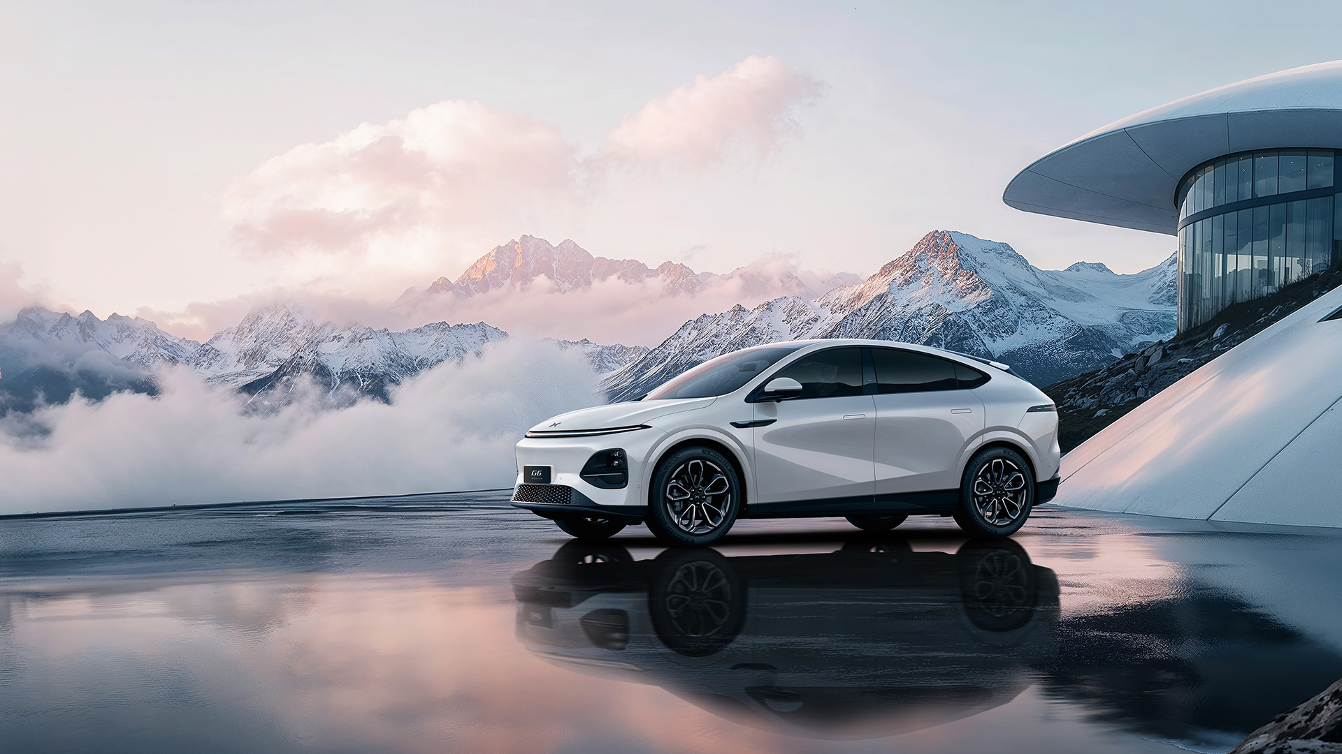 The 2026 XPENG G6 parked in front of snowcapped mountains